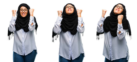Arab woman wearing hijab happy and excited celebrating victory expressing big success, power, energy and positive emotions. Celebrates new job joyful isolated over white background