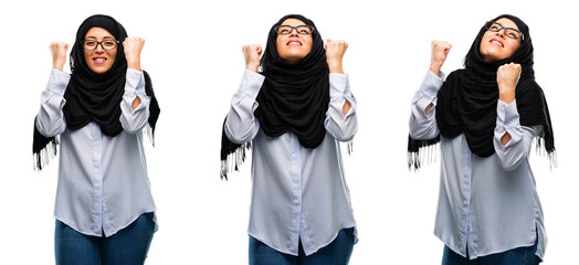 Arab woman wearing hijab happy and excited celebrating victory expressing big success, power,...