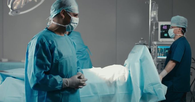 Silly doctors dancing in a modern operating theater. 4K UHD 