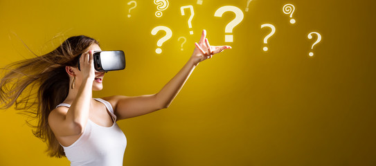 Qeustion Marks with young woman using a virtual reality headset