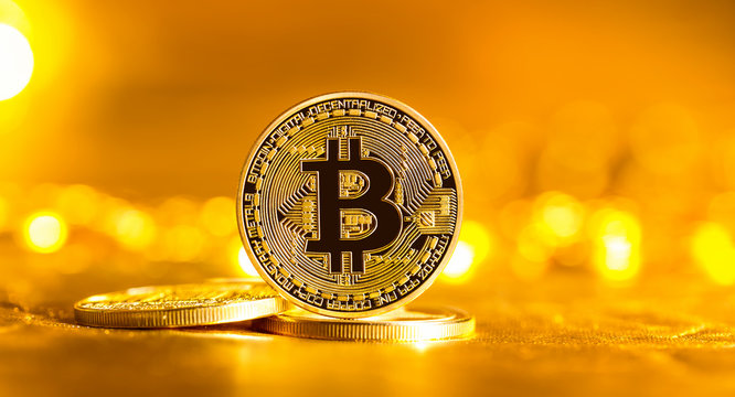 Bitcoin cryptocurrency coin on a bright gold background