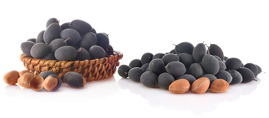 velvet tamarind fruit ( Dialium cochinchinense) isolated on white.