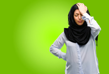 Young arab woman wearing hijab stressful keeping hand on head, tired and frustrated