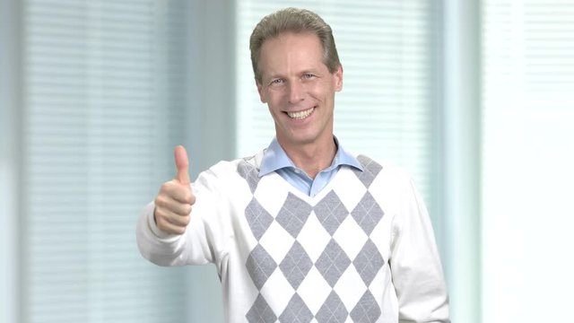 Satisfied mature man with thumb up. Happy caucasian man showing gesture ok. Cheerful european middle-aged guy.