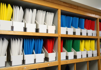 colorful folders on the shelf in the office