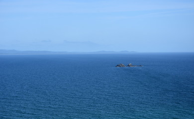 Julia Rocks in the Tasman Sea. Sea view from Byron Bay on a sunny day. Julian Rocks is a Marine...