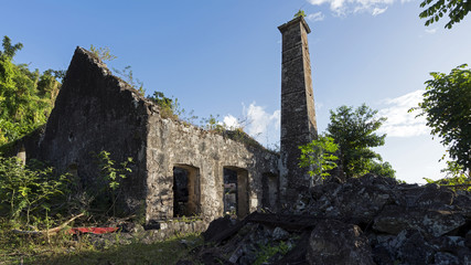 Fototapeta na wymiar Sugar Mill ruins in Dominica. Sugar was the source of West Indies wealth for centuries. Growing sugar cane and processing was labor intensive and grueling, leading to intensive use of slave labor.