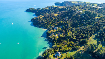 Aerial view on a beautiful harbour surrounding rocky peninsula with residential houses. Waiheke...
