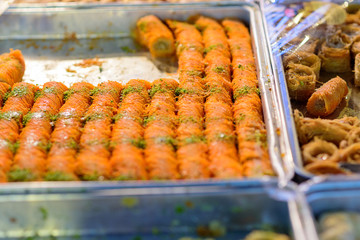 Arabic sweets for celebrate holidays ramadan, iftar,eid on the tray in the market.Selective focus.
