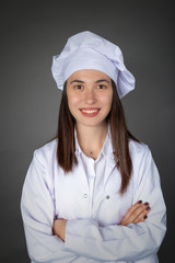 Beautiful Turkish smiling young female chef with confident expression