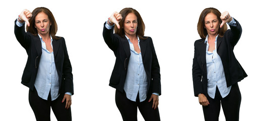 Middle age business woman showing thumbs down unhappy sign of dislike, negative expression and...