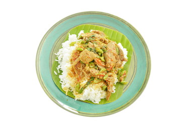 spicy fried duck meat curry with basil leaf and rice on fresh banana leaf