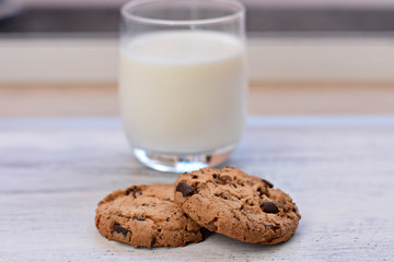 Chocolate chips cookies/ American cookies/ and healthy glass of milk and light wooden background/ Healthy morning 