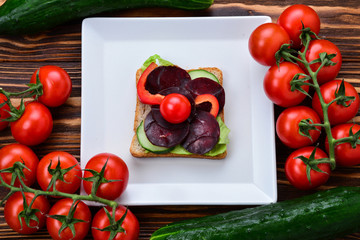 Sandwiches with different meat and vegetables.