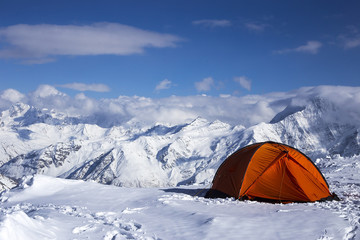 orange tent against the mountains