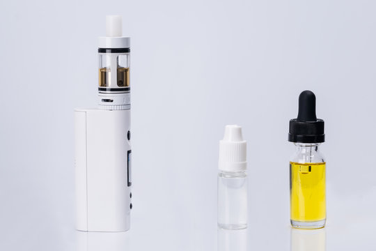 electronic cigarette and liquid for its refueling on a white background