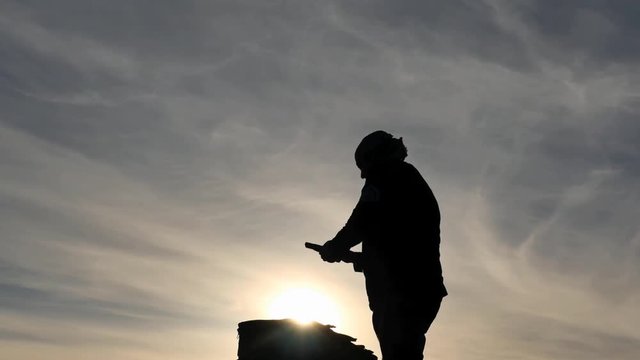 man Silhouette hiding prohibited for airlines passeger luggage items to suitcase dolly shot