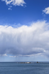 Beautiful sunny summer coast view from Bay Of Fires to blue Tasman Sea with crystal clear water surrounded by red orange colorful shore rocks and white sandy beach, Cosy Corner, Tasmania, Australia