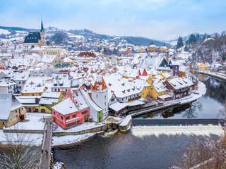 Panoramic view of Cesky Krumlov in winter season, Czech Republic. View of the snow-covered roofs. Travel and Holiday in Europe. Christmas and New Year time. Sunny winter day in european town.