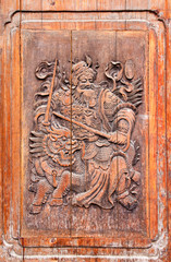 Traditional Chinese wooden door with martial art carving - fighting against devil with lions