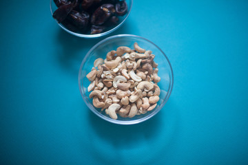 Cashew nuts in a transparent Cup on the table.