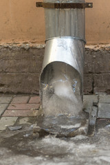 The frozen water from the drainage pipe