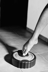 Modern robotic vacuum cleaner domestic appliance on the floor background. Indoor housekeeping electronic smart technology autonomous convenience concept