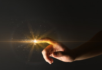 Female finger touching a beam of light