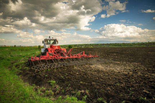 Tractor plowing fields. Preparing land for sowing.