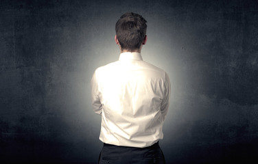 Young businessman standing and thinking alone