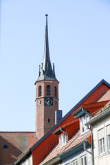 Fototapeta premium Salzwedel, Germany - April 20, 2018: View of the tower of the Lorenzkirche in Salzwedel, Germany.