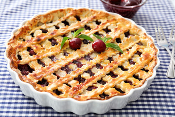 Delicious cherry pie on kitchen table