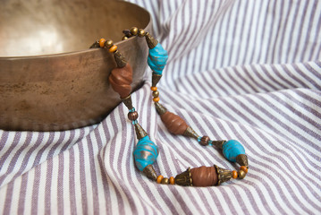 Bohemian turquoise and brown beads in ethnic style on striped fabric. Handmade jewelry from polymer...