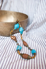 Bohemian turquoise and brown beads in ethnic style on striped fabric. Handmade jewelry from polymer...