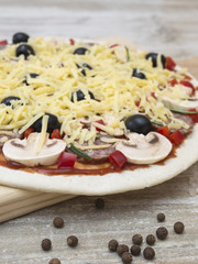 ingredients for pizza making on a wooden table. 