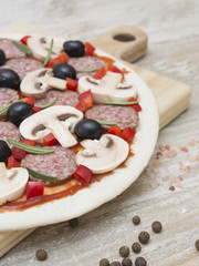ingredients for pizza making on a wooden table. 