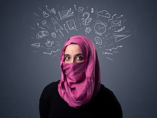 Young muslim woman wearing niqab with mixed white drawings above her head