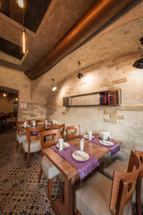 Fototapeta na wymiar Rustik interior of restaurant with setting tables for dinner