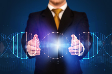 Businessman with DNA concept in his hands 