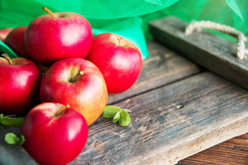 ripe red apples on wooden background