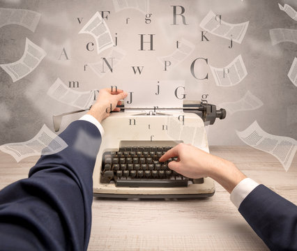 First person perspective hand typewriting with flying documents around
