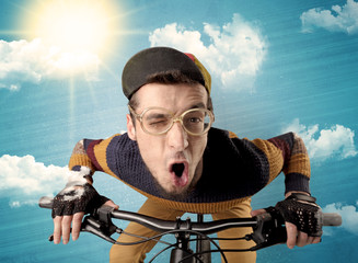 Nerd, crazy stylish rider on the bicycle with sunny weather