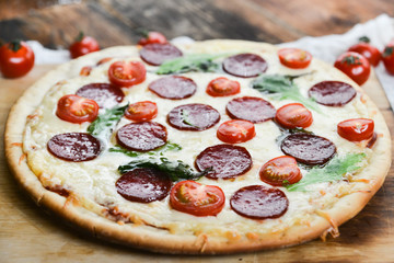Tasty Pizza With Tomato Sauce, Pepperoni Sausage, And Mushrooms On Wooden Background Natural Rustic, A Pizza Cutter And Ingridienty.