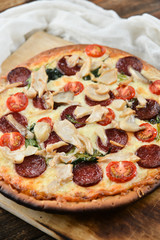 Pizza With Tomato Sauce, Pepperoni Sausage, And Mushrooms On Wooden Background Natural Rustic, A Pizza Cutter And Ingridienty.