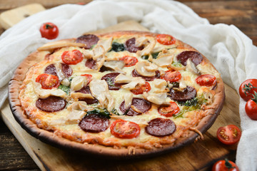 Pizza With Tomato Sauce, Pepperoni Sausage, And Mushrooms On Wooden Background Natural Rustic, A Pizza Cutter And Ingridienty.