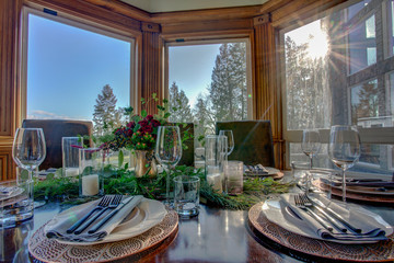 Elegant table set for dinner and beautiful window view.