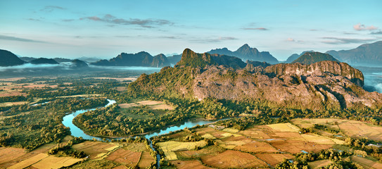 Aerial view of a rice fields in rocky mountain valley and river