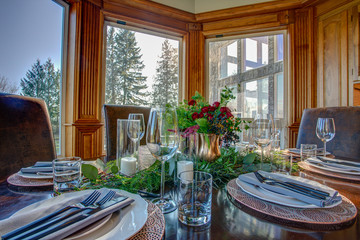 Elegant table set for dinner and beautiful window view.