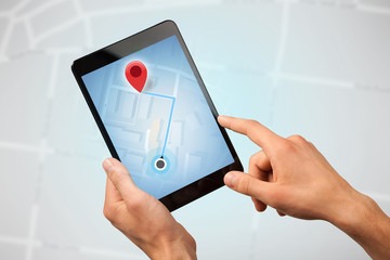 Female fingers touching tablet with map