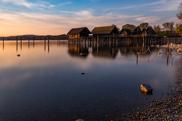 Colorfull sunset at Lake Dwellings of the Stone and Bronze Age in Unteruhldingen on Lake Constance,...